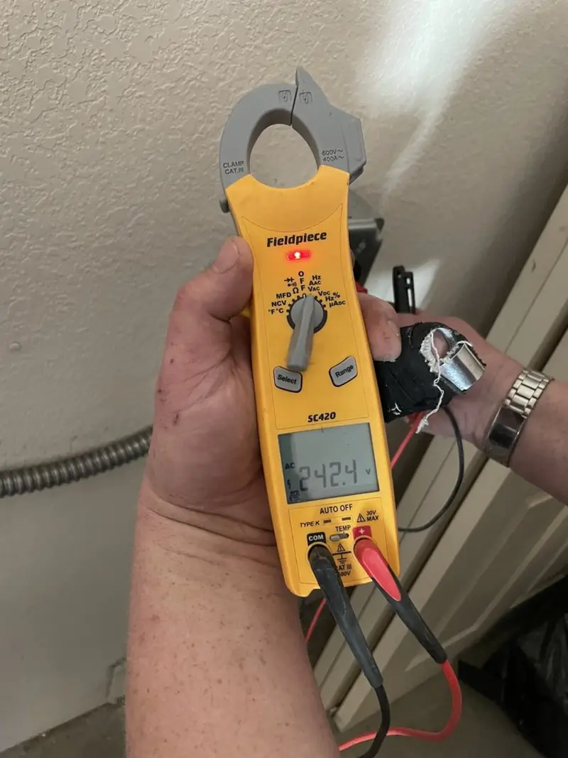 Voltage testing with clamp meter during Outlet Installation in Davison
